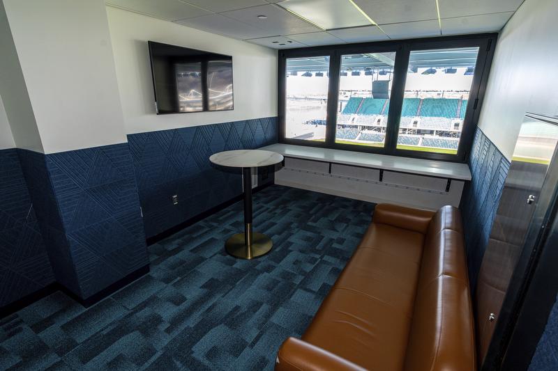 A view of the press level suite room setup with couch and cocktail table.