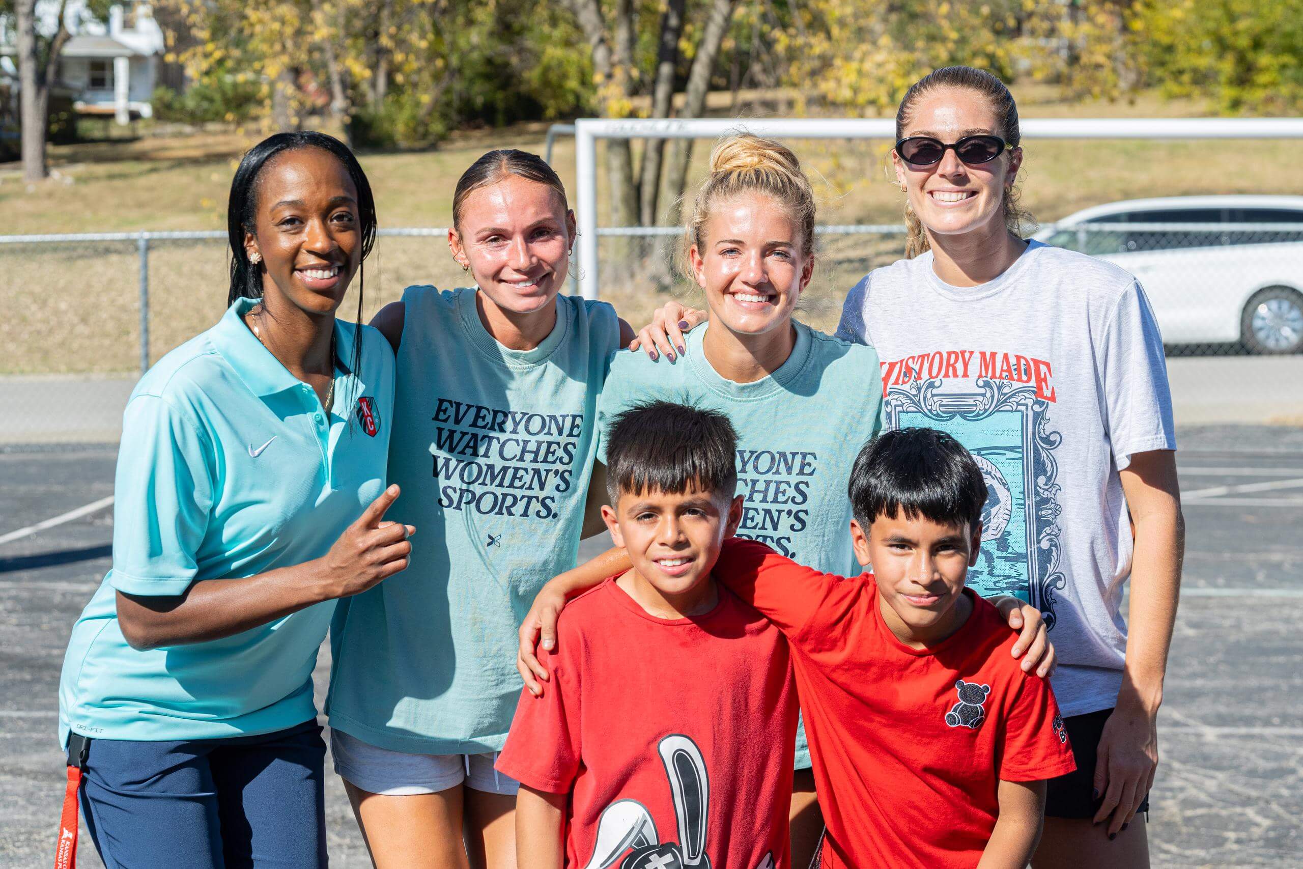 Players and Banneker Elementary Students and staff take photo at mini pitch event.