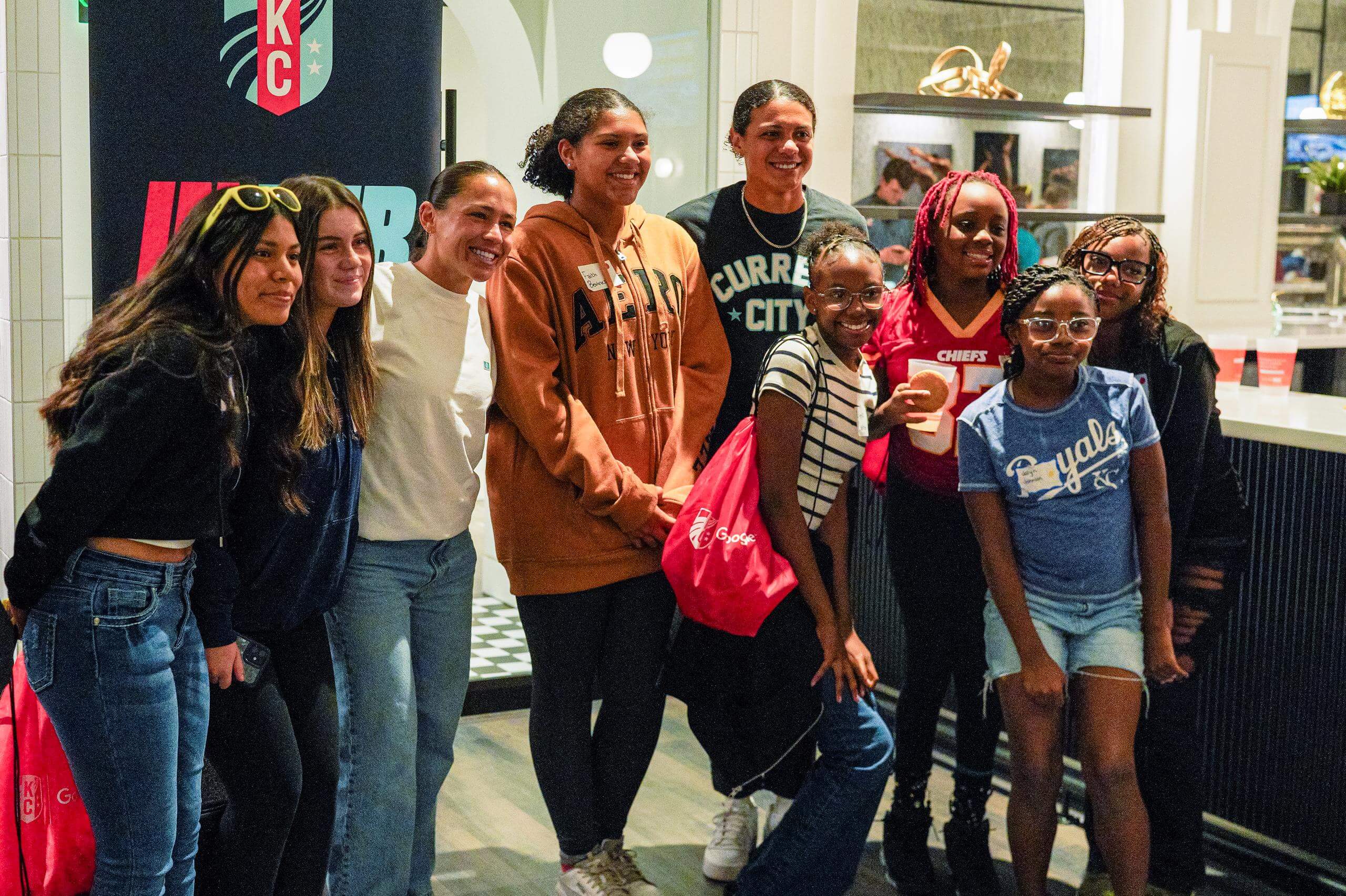 Students taking pictures with Lo and Alana Cook at the In her boots event.