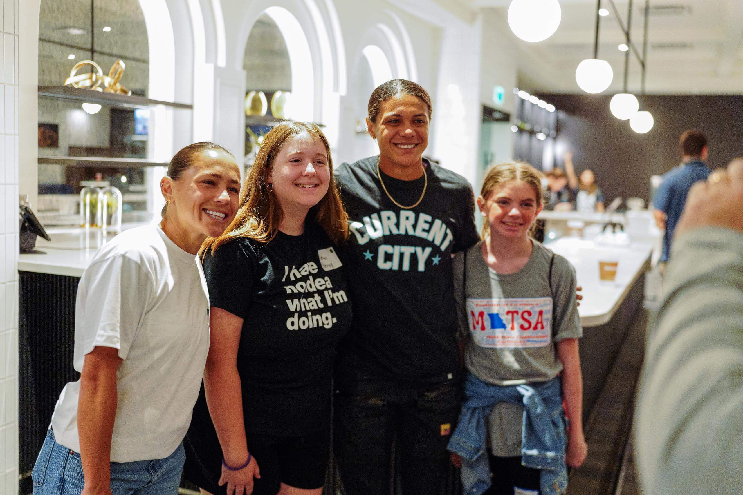 Students taking pictures with Lo and Alana Cook at the In her boots event.